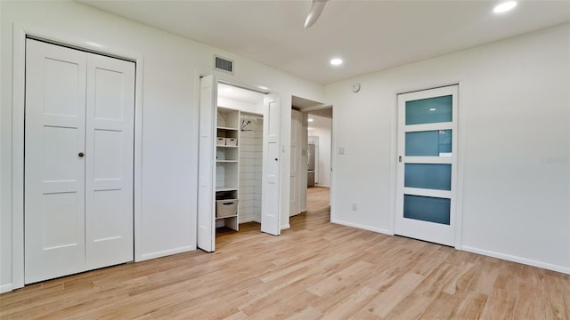 unfurnished bedroom featuring light hardwood / wood-style flooring and ceiling fan