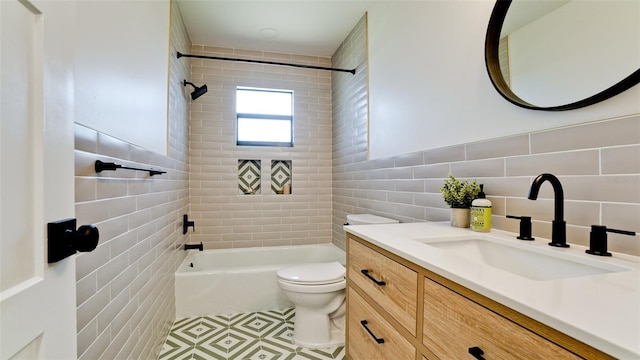 full bathroom featuring backsplash, toilet, tiled shower / bath, vanity, and tile floors