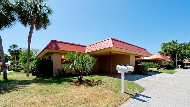 view of front facade with a front lawn and a carport