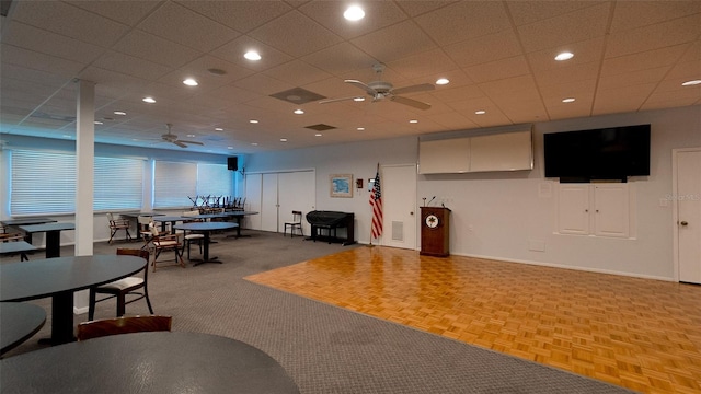 carpeted living room with ceiling fan