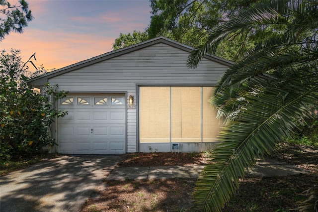 view of garage at dusk