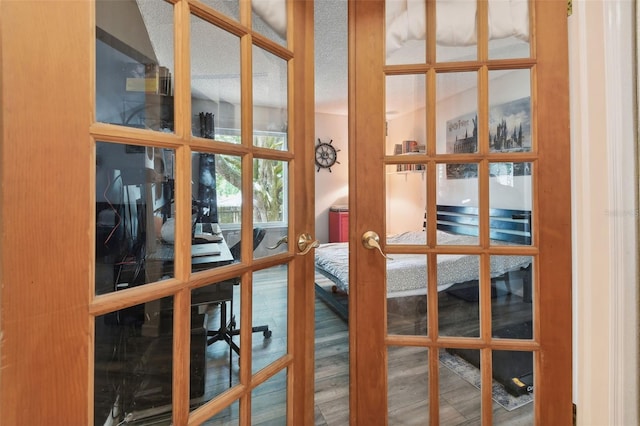 interior space with wood-type flooring and french doors