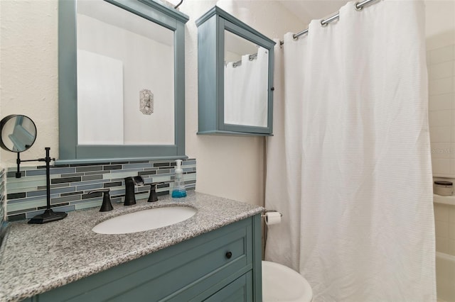 full bathroom with shower / tub combo, tasteful backsplash, toilet, and vanity with extensive cabinet space