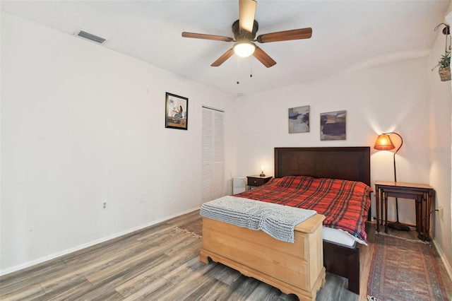 bedroom featuring a closet, wood-type flooring, and ceiling fan