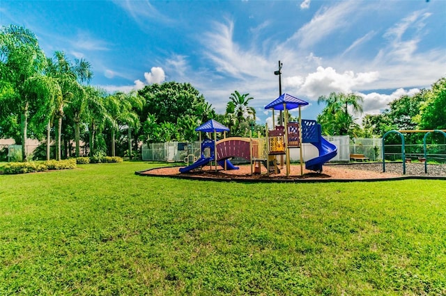 view of playground with a lawn