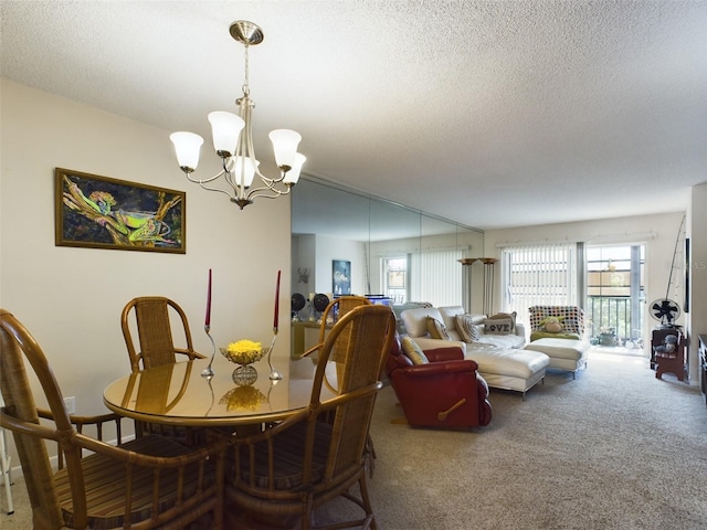 carpeted dining room featuring a chandelier and a textured ceiling