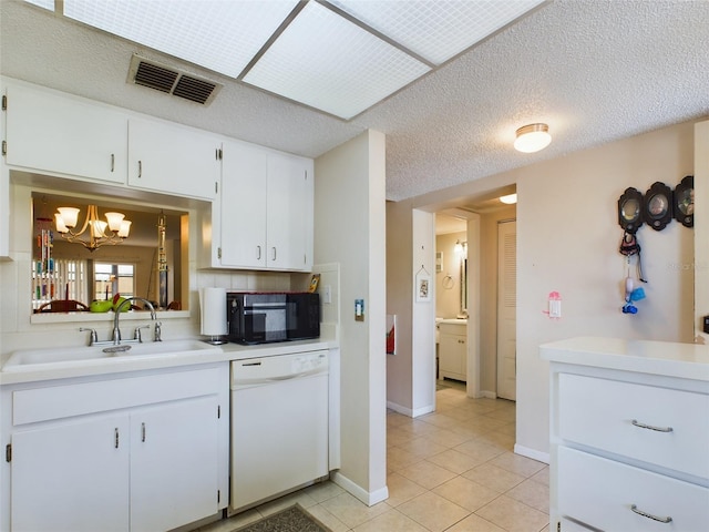 kitchen with white cabinetry, a chandelier, light tile floors, dishwasher, and a textured ceiling