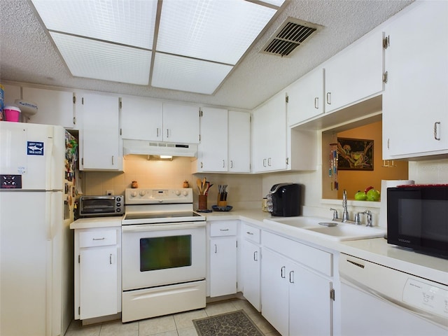 kitchen with white appliances, light tile flooring, white cabinetry, backsplash, and sink