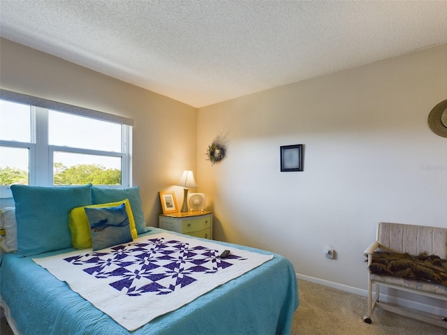 bedroom with a textured ceiling and carpet floors