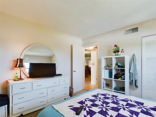 carpeted bedroom featuring a textured ceiling