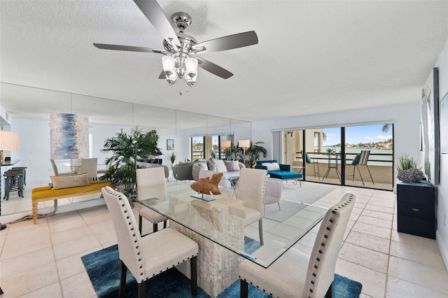 dining room featuring ceiling fan, a textured ceiling, and light tile patterned flooring