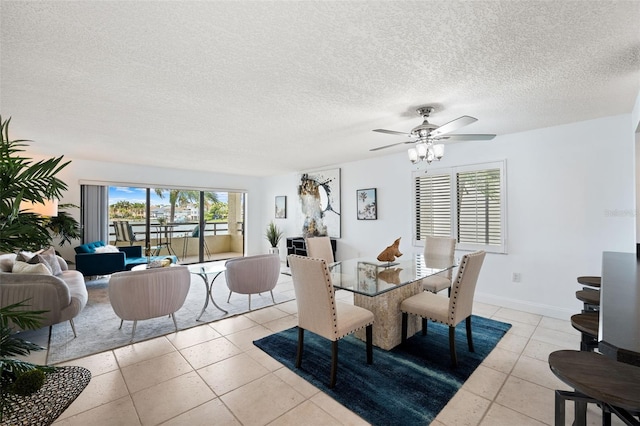 dining area featuring a textured ceiling, light tile patterned flooring, and ceiling fan