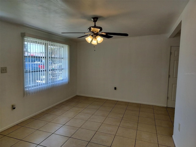 tiled empty room with ceiling fan