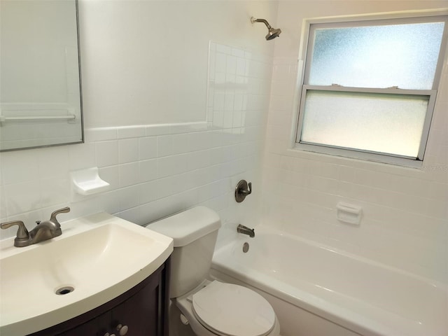 full bathroom featuring a wealth of natural light, tiled shower / bath combo, tile walls, and toilet