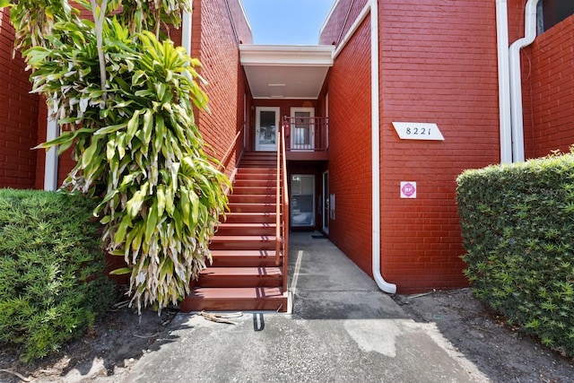 entrance to property featuring brick siding