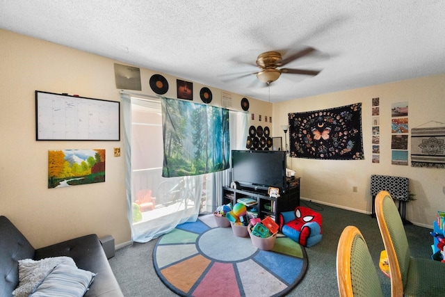 rec room with carpet flooring, ceiling fan, and a textured ceiling