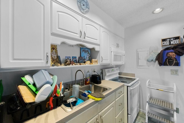 kitchen featuring white cabinetry, white appliances, a textured ceiling, and light tile flooring