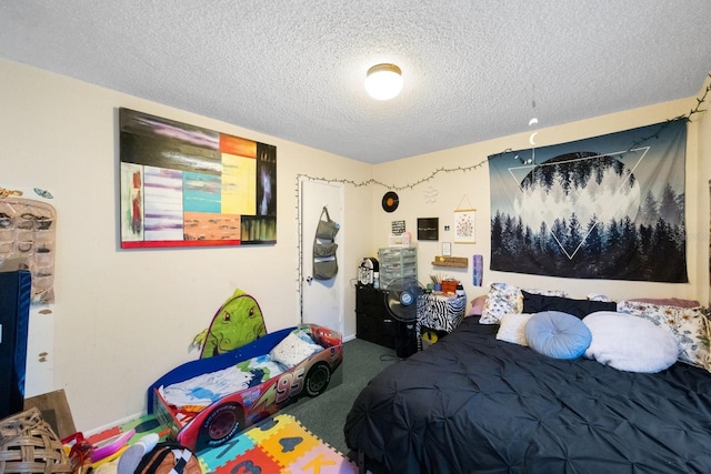 bedroom with a textured ceiling and carpet