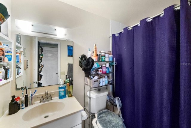 bathroom featuring oversized vanity and toilet