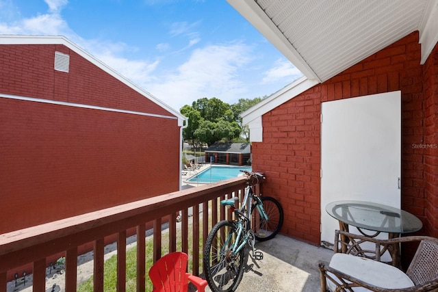 balcony with a fenced in pool