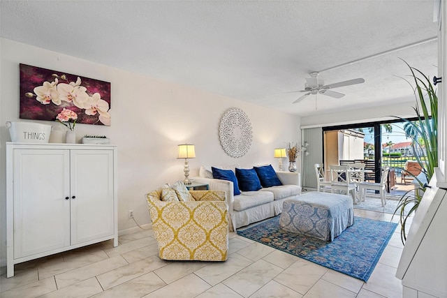 tiled living room featuring ceiling fan and a textured ceiling