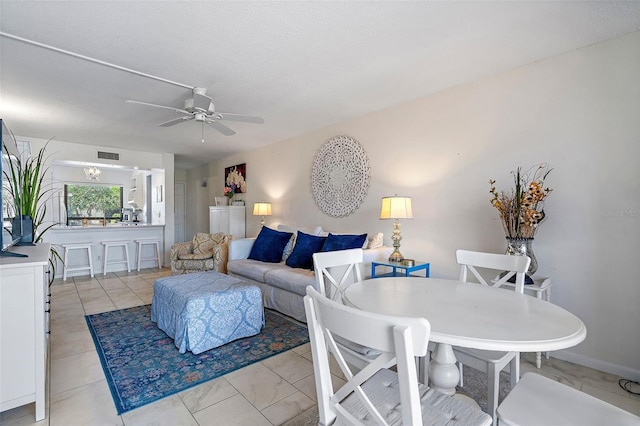 living room with ceiling fan and light tile flooring