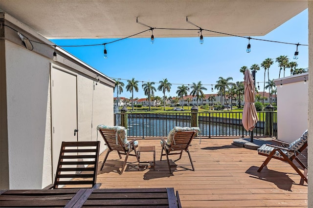 wooden terrace featuring a water view