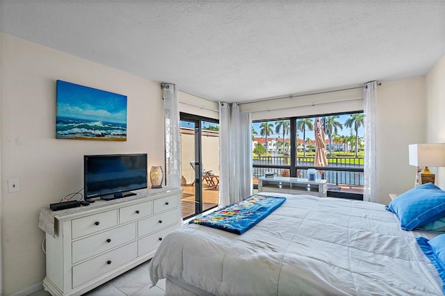 tiled bedroom featuring access to exterior and a textured ceiling