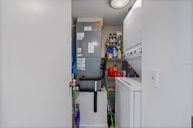 utility room featuring stacked washer and dryer