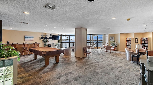 rec room featuring floor to ceiling windows, a textured ceiling, pool table, and carpet flooring