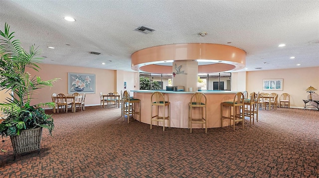 kitchen with carpet and a textured ceiling