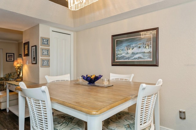 dining room with hardwood / wood-style floors and a notable chandelier