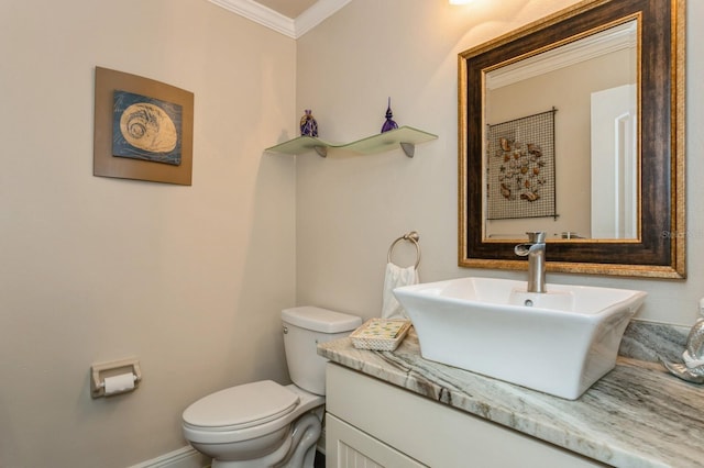 bathroom with vanity with extensive cabinet space, toilet, and crown molding