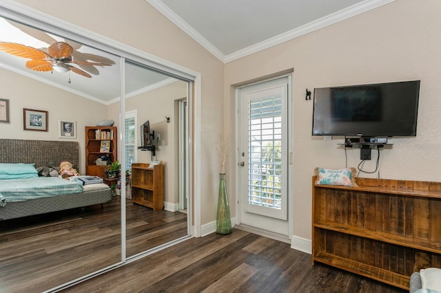 bedroom with ornamental molding, dark hardwood / wood-style flooring, ceiling fan, and vaulted ceiling