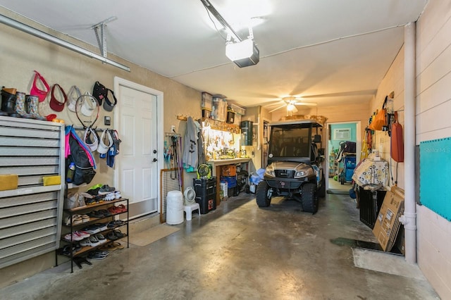 garage featuring ceiling fan, a workshop area, and a garage door opener