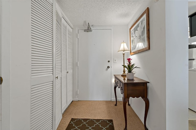 corridor featuring carpet and a textured ceiling