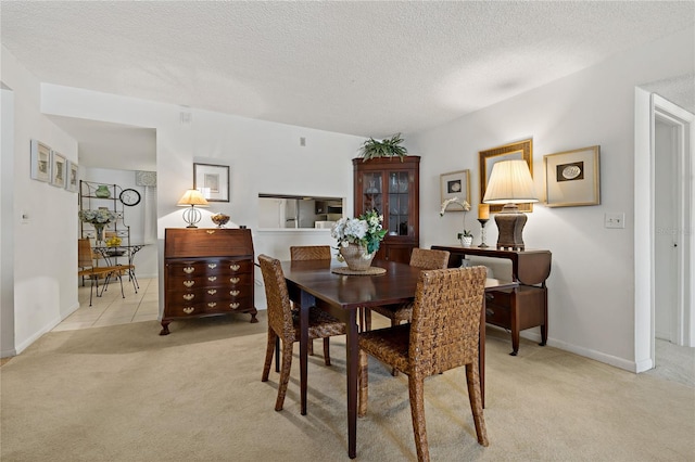 tiled dining area with a textured ceiling