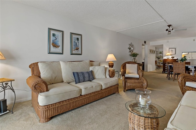 carpeted living room featuring ceiling fan and a textured ceiling