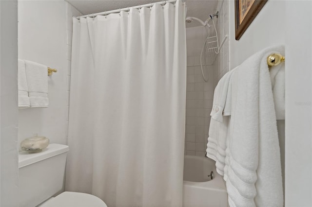 bathroom with a textured ceiling, toilet, and shower / bath combo