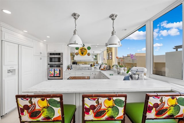 kitchen featuring white cabinetry, sink, paneled built in refrigerator, and double oven