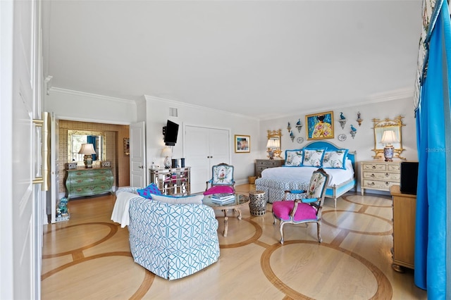 bedroom with crown molding and hardwood / wood-style floors