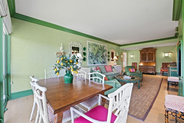 dining area featuring ornamental molding and wood-type flooring