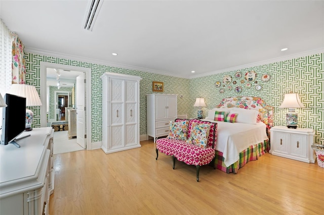 bedroom with ornamental molding and light wood-type flooring