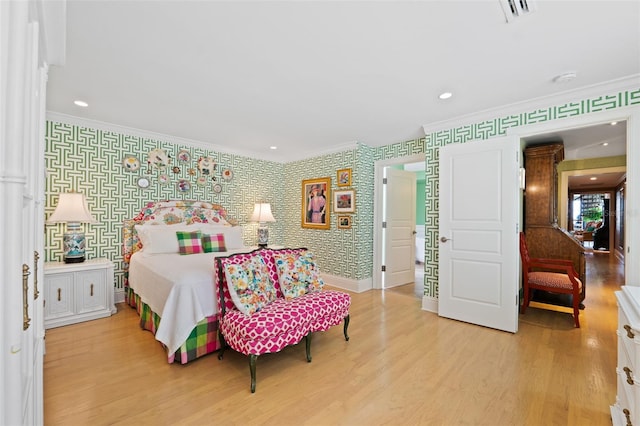 bedroom featuring ornamental molding and light wood-type flooring