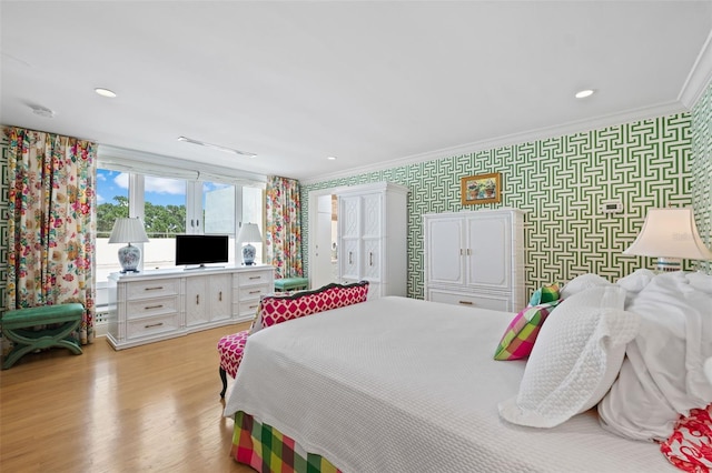 bedroom featuring crown molding and light wood-type flooring