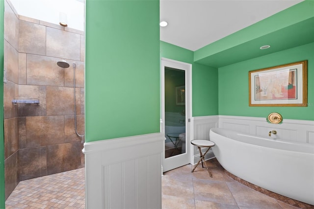 bathroom featuring tile floors and separate shower and tub