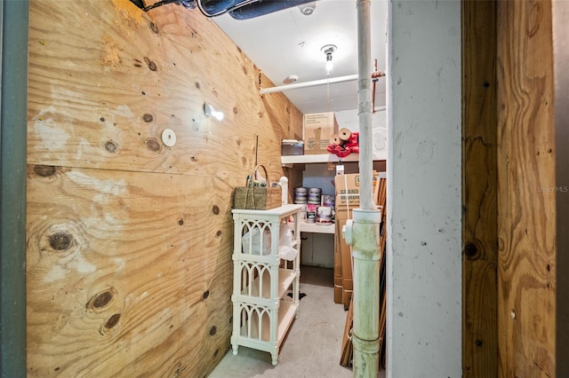 hallway featuring wood walls