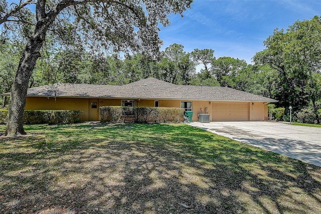 single story home with a front yard and a garage