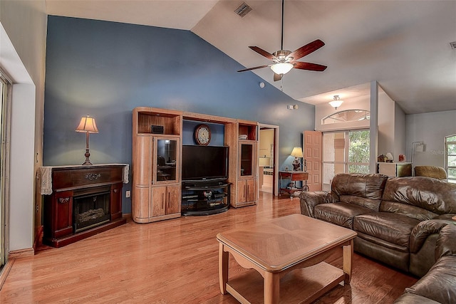 living room with high vaulted ceiling, ceiling fan, and wood-type flooring