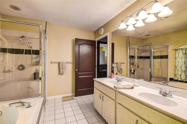 bathroom with tile floors, a textured ceiling, dual vanity, and independent shower and bath